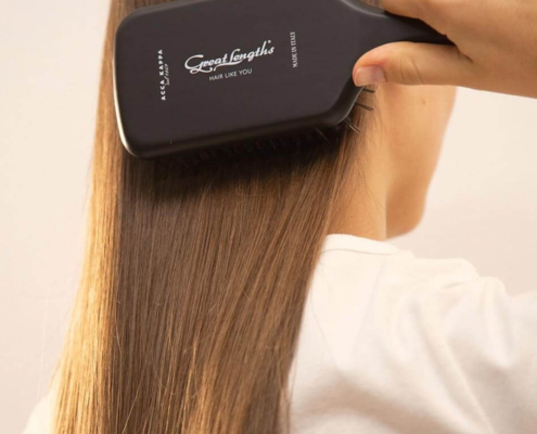 brushing hair with paddle brush